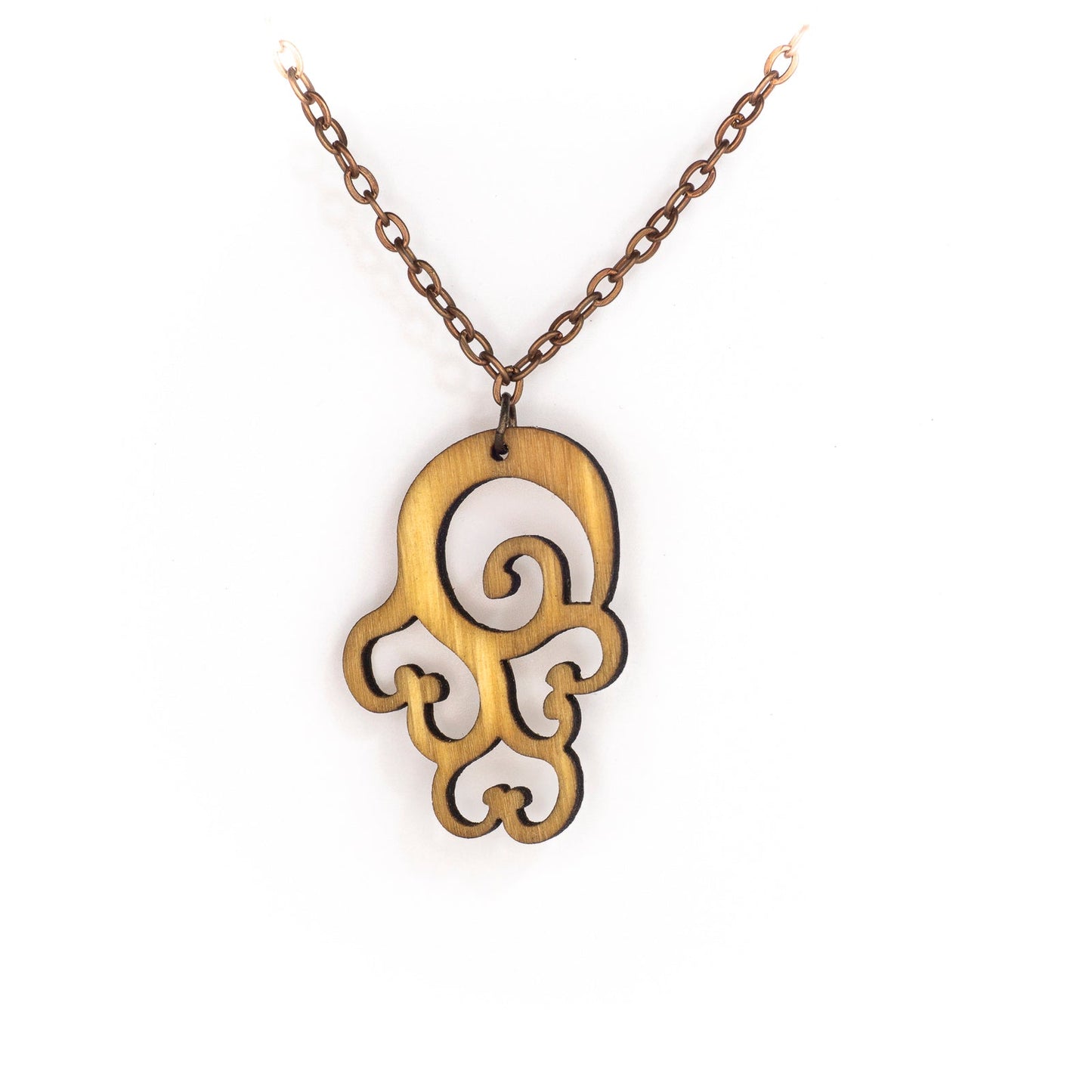 A delicate copper chain hangs in a 'V', at its apex is a bright birch wood pendant. The pendant is an abstract design loosing forming a laser cut swirl with three laser cut upside down hearts seeming to dangle beneath it. The thick curving lines are emotive of billowing clouds and sensuous curves.