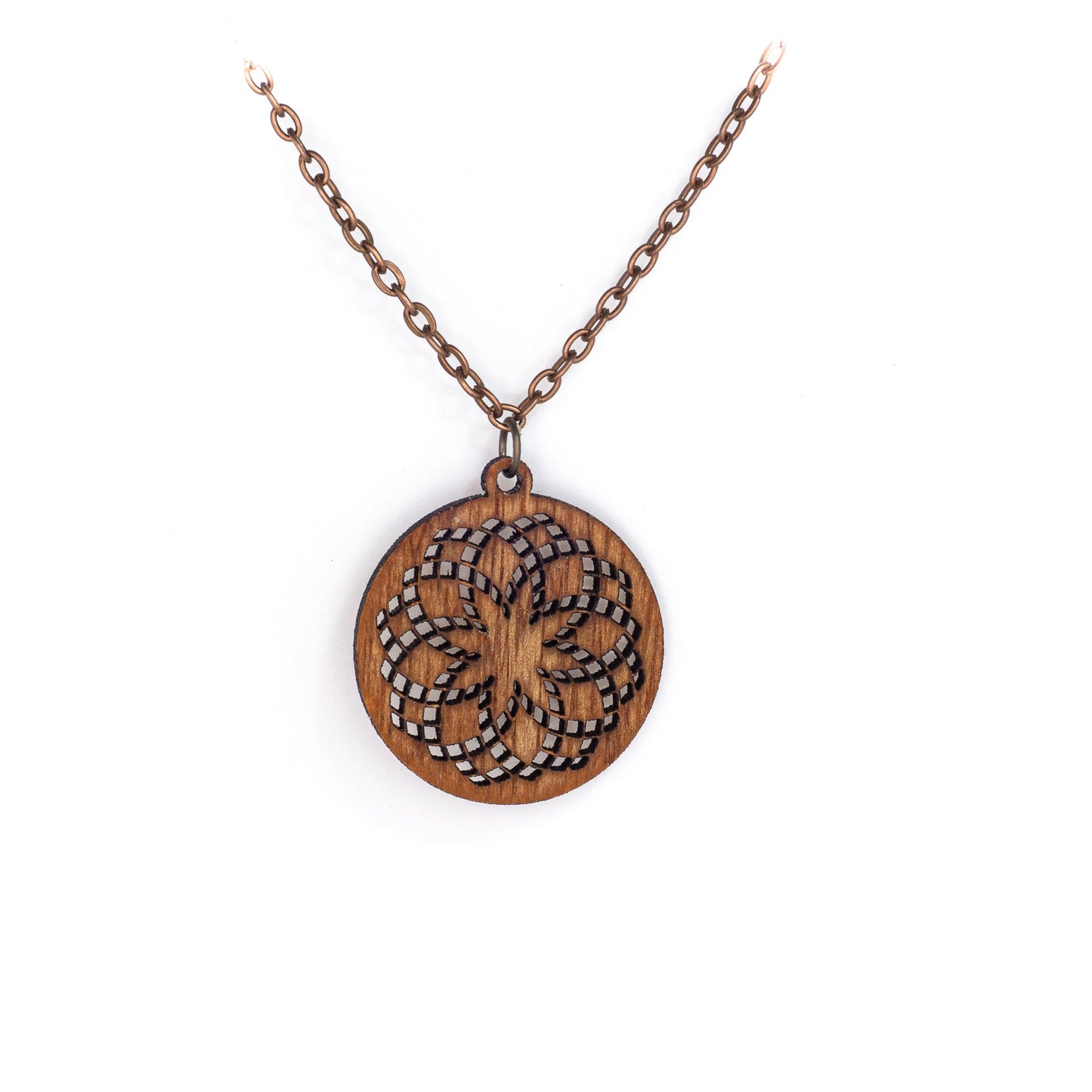 A delicate copper chain hangs in a 'V', at its apex is a small round mahogany wood pendant with a laser cut design. The design is illustrative of sacred geometry with repeating circles creating a fractal effect loosely resembling a flower with an eight pointed star in the center.